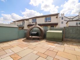 A garden with patio and furniture at Hillside in 