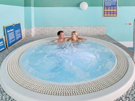 A spa with a hot tub and rules displayed at Tide’s Reach - Hayling Island