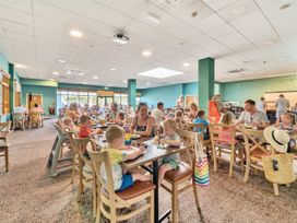 A dining room with families eating at Tide’s Reach - Hayling Island