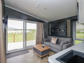A living room with a sofa and coffee table at Heron in Haverigg