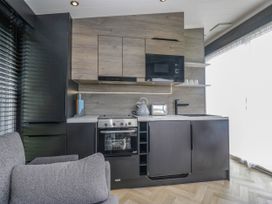 A kitchen with cabinets and appliances at Heron in Haverigg