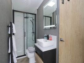 A bathroom with a shower and sink at Heron Haverigg