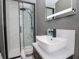 A bathroom with a shower and sink at Heron in Haverigg
