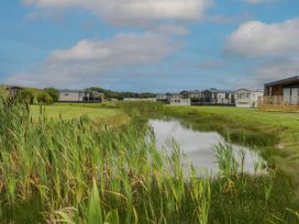 A view of mobile homes alongside a pond at Heron in Haverigg