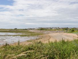 A beach with houses in the background at Heron Haverigg