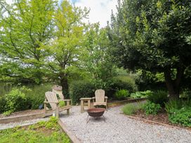 A garden with two chairs and a fire pit at Shepherds Hut Truro