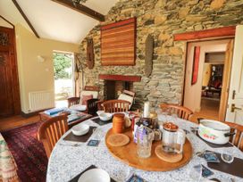 A dining room with a table set for a meal at The School House in Penrith