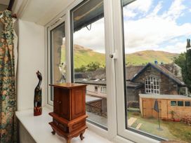 A window view with mountain landscape and garden at The School House Penrith