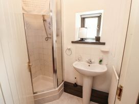 A bathroom with a shower and sink at The School House in Penrith