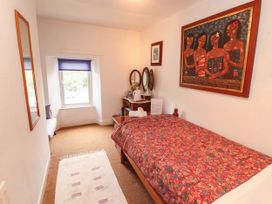 A bedroom with a bed and mirrors at The School House in Penrith