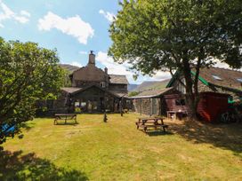 An outdoor area with a house and benches at The School House in Penrith