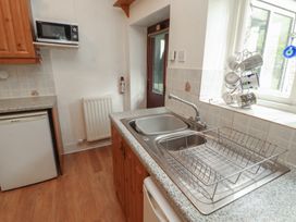 A kitchen with a sink and microwave at The School House in Patterdale near Glenridding