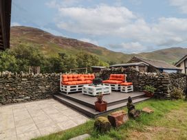 A garden with outdoor seating and a fire pit at The School House in Patterdale near Glenridding