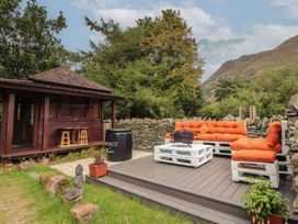 An outdoor seating area with a fire pit and furniture at The School House Patterdale near Glenridding