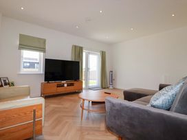 A living room with a television and coffee table at Edens in Penwithick
