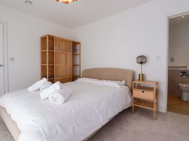 A bedroom with a bed and a bookshelf at Edens in Penwithick