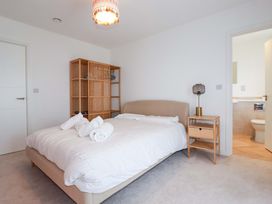 A bedroom with a bed and a bookshelf at Edens Penwithick