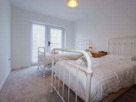A bedroom with two beds and a dresser at Edens in Penwithick