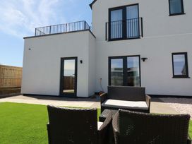 A garden with chairs and table at Edens in Penwithick