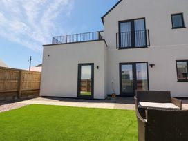 An outdoor area with grass and patio at Edens in Penwithick