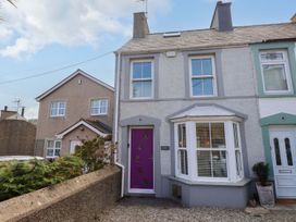 A house with a purple door and bay window at Bodefi in Pwllheli
