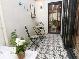 A patio with a table and chairs at Bodefi in Pwllheli