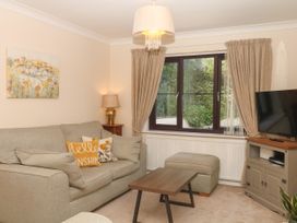 A living room with a sofa and table at Marldon Mews in Marldon