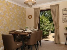 A dining room with table and chairs at Marldon Mews in Marldon