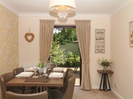 A dining room with a table set for meals at Marldon Mews in Marldon