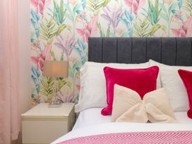 A bedroom with a bed and lamp at Marldon Mews in Marldon