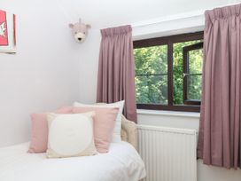 A bedroom with a bed and window at Marldon Mews in Marldon