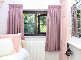 A bedroom with a bed and window at Marldon Mews in Marldon