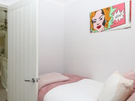 A bedroom with a bed and artwork on the wall at Marldon Mews in Marldon