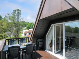 An outdoor dining area with a table and chairs at 9 Honicombe Park in Callington