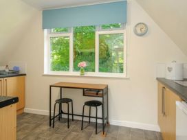 A kitchen with a table near a window at 9 Honicombe Park Callington