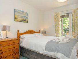 A bedroom with a bed and dresser at 9 Honicombe Park in Callington