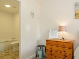 A bathroom with a bathtub and toilet at 9 Honicombe Park in Callington