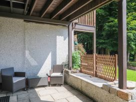 A patio area with chairs and a fence at 9 Honicombe Park in Callington