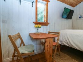 A bedroom with a table and chairs at Ardwyn in Pwllheli