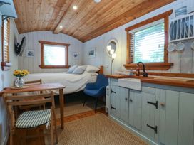A bedroom with a bed and small dining area at Ardwyn in Pwllheli