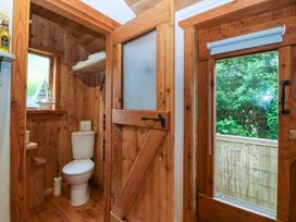 A bathroom with a toilet and window at Ardwyn in Pwllheli