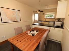 A dining room with a table and chairs at Sarah's Cottage
