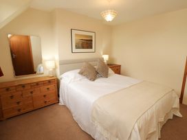A bedroom with a bed and furniture at Sarah's Cottage