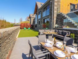An outdoor dining area with a table and chairs at Midways in Windermere