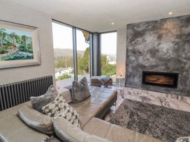 A living room with a sofa and painting at Midways in Windermere