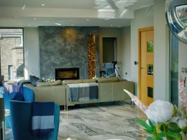 A living room with a sofa and fireplace at Midways in Windermere