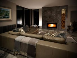 A living room with a sofa and a fireplace at Midways in Windermere