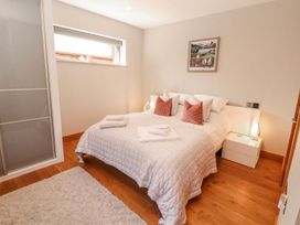 A bedroom with a bed and bedside table at Midways in Windermere