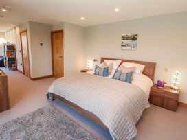 A bedroom with a bed and bedside tables at Midways in Windermere