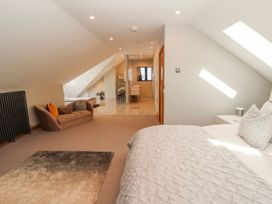 A bedroom with a bed and sofa at Midways in Windermere